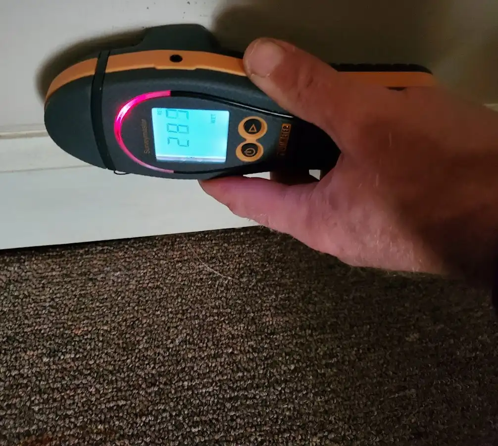 Moisture detection at baseboard during Storm Damage Restoration in Pennsville
